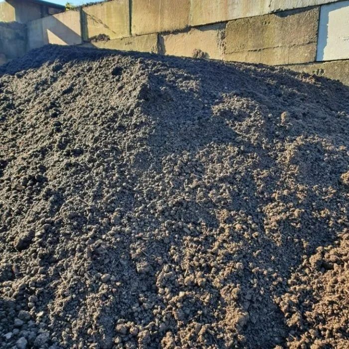Pile of Dark, Rich Soil in Front of Concrete Blocks — Port Landscape Supplies in Port Macquarie, NSW