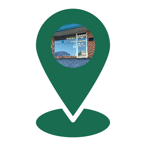 A green pin with a picture of a house inside of it.