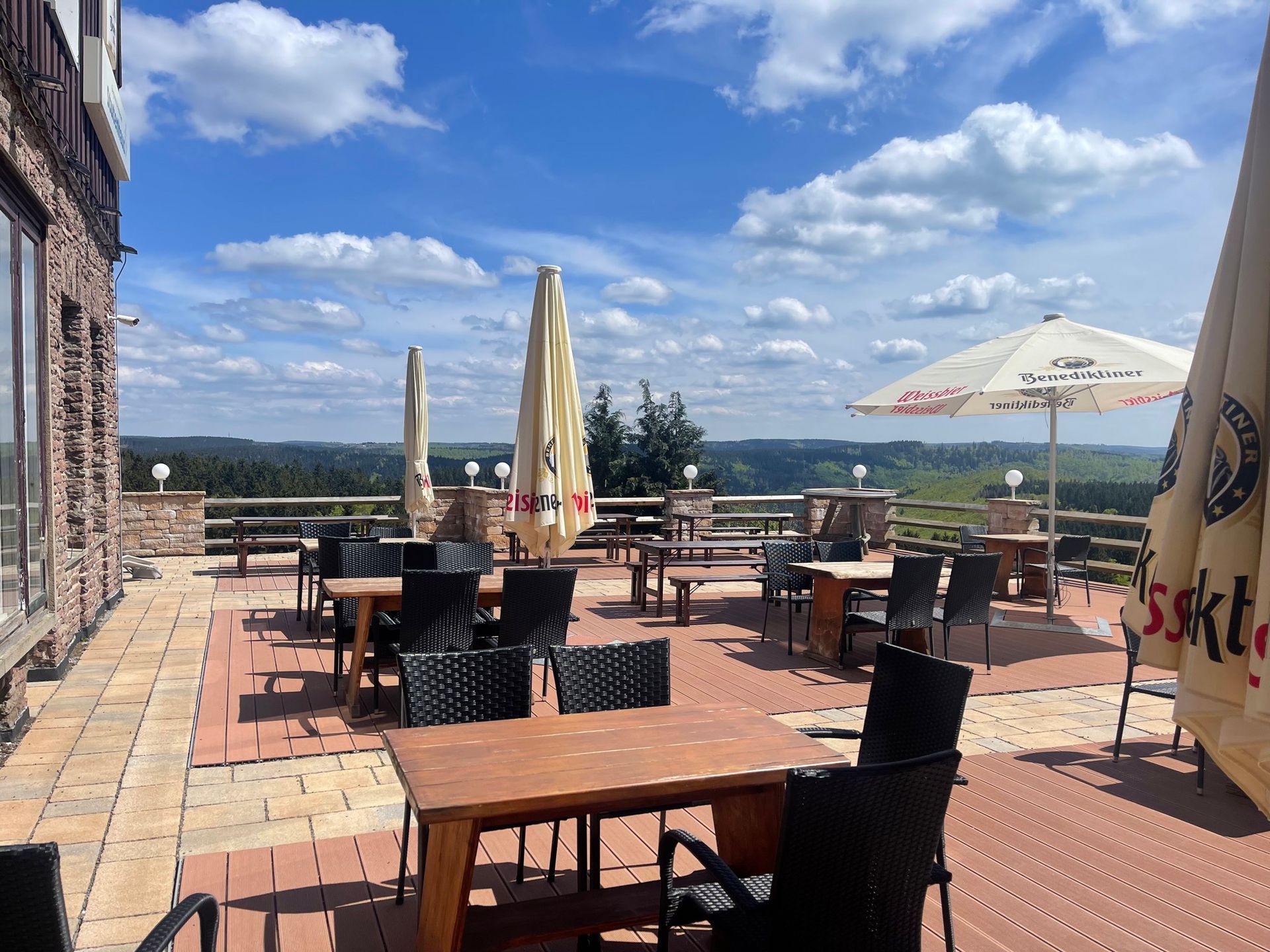 A patio with tables and chairs and umbrellas with the word ssk on them