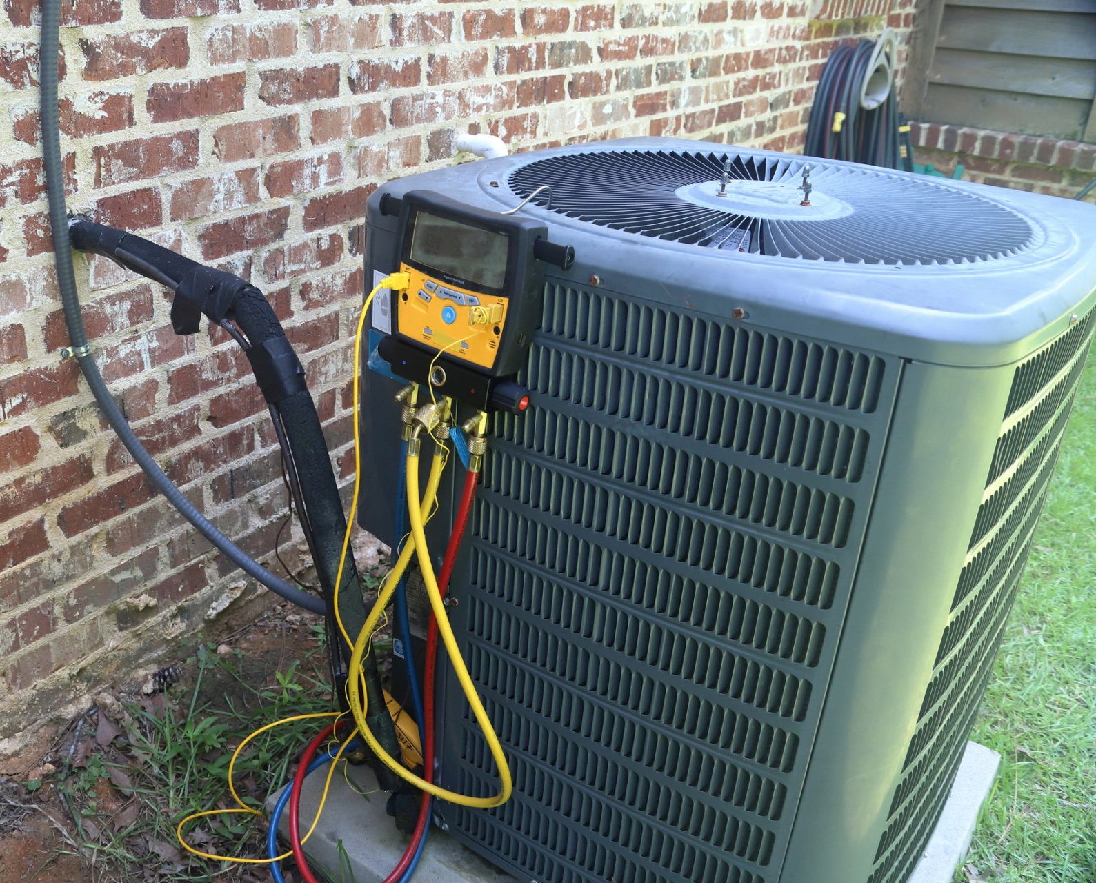 HVAC Technician Servicing An Air Conditioning Unit
