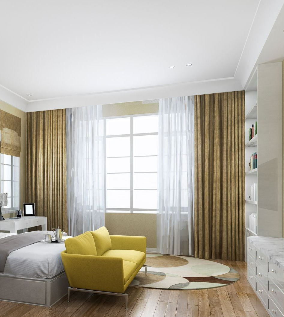 Bedroom with yellow sofa, bed, large window, gold curtains, and built-in white cabinets. Bedroom with gold curtains, yellow sofa, and window with white sheer curtains.