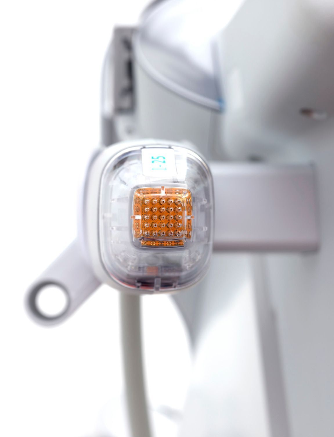 Transparent amber bicycle light mounted on a white frame close-up
