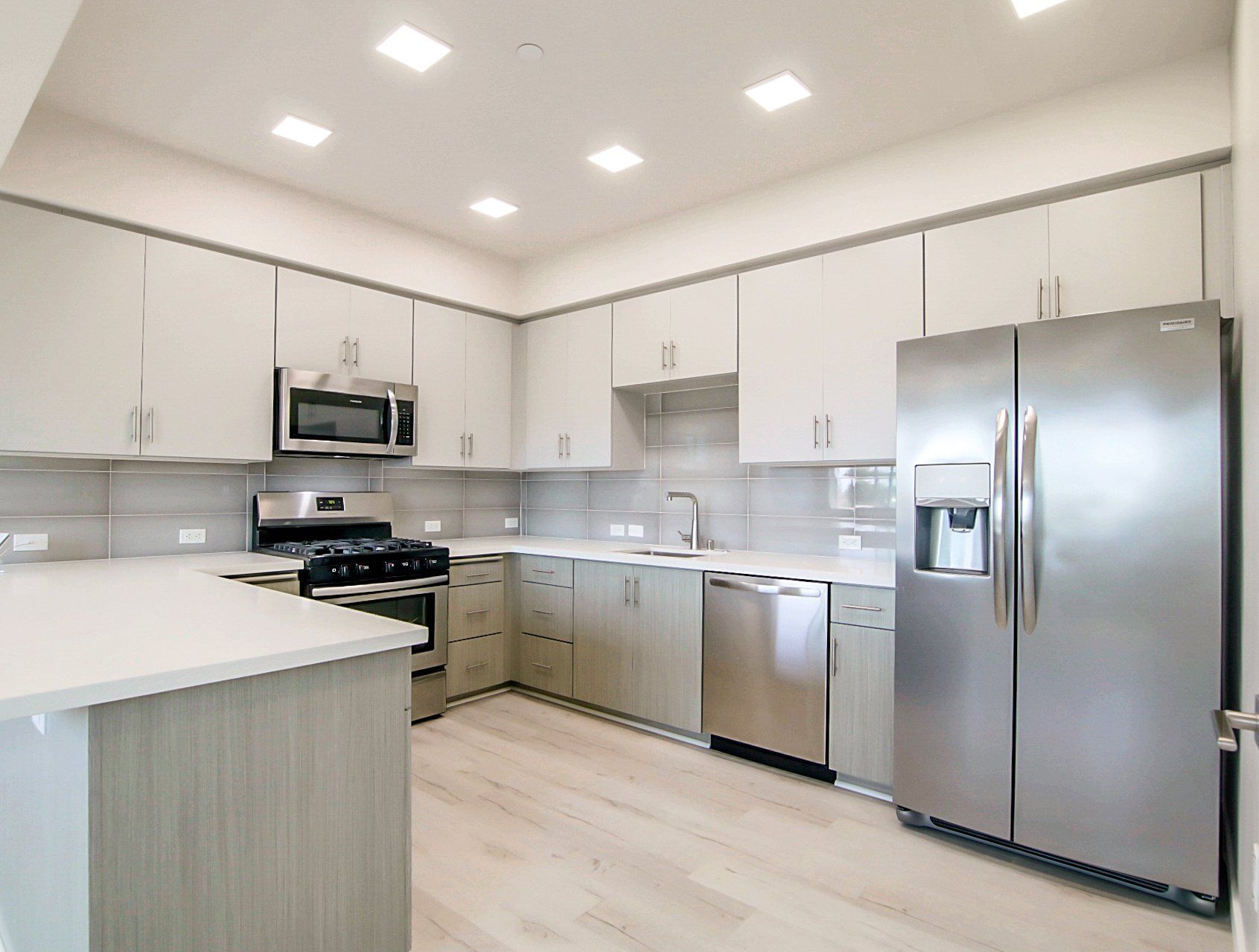 Modern kitchen with hardwood and stainless steel appliances