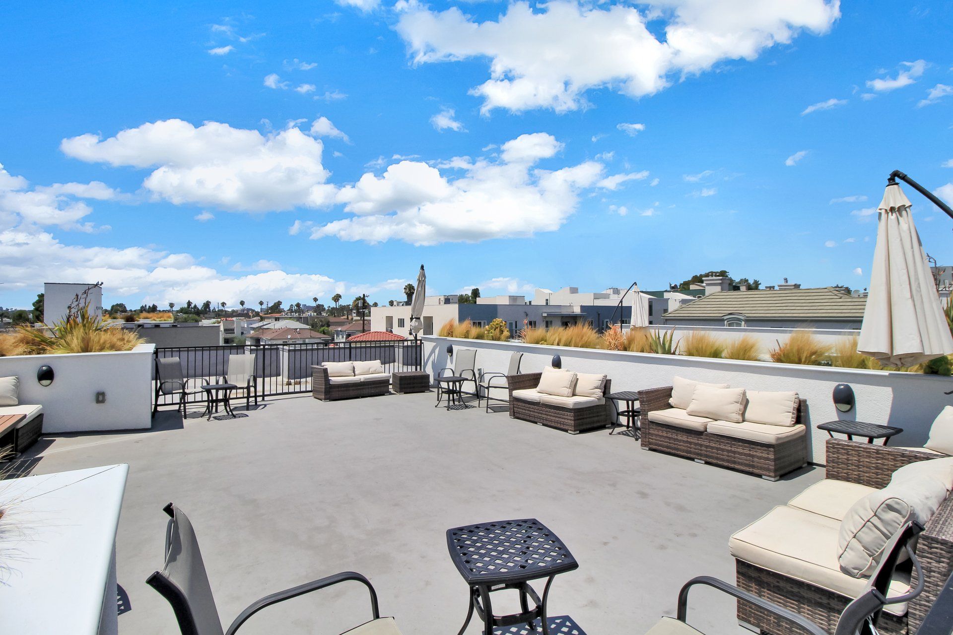 Rooftop deck with patio table and lounge seating.