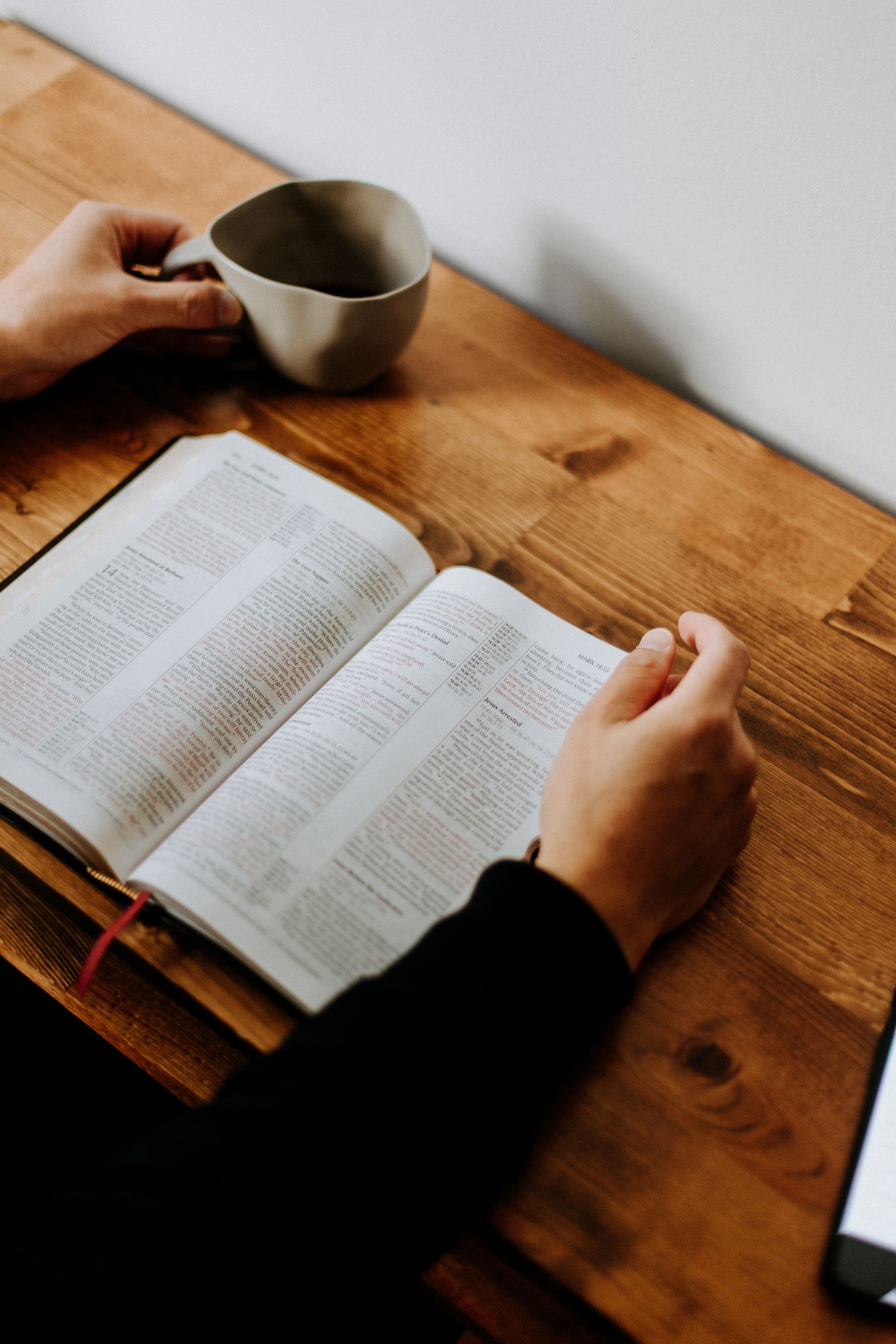 Person studying a Bible on a table