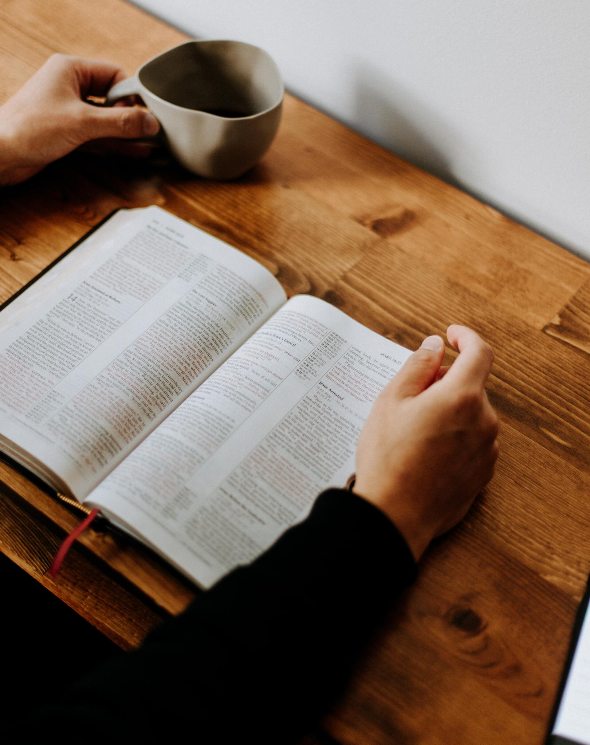 Person studying Bible on a table