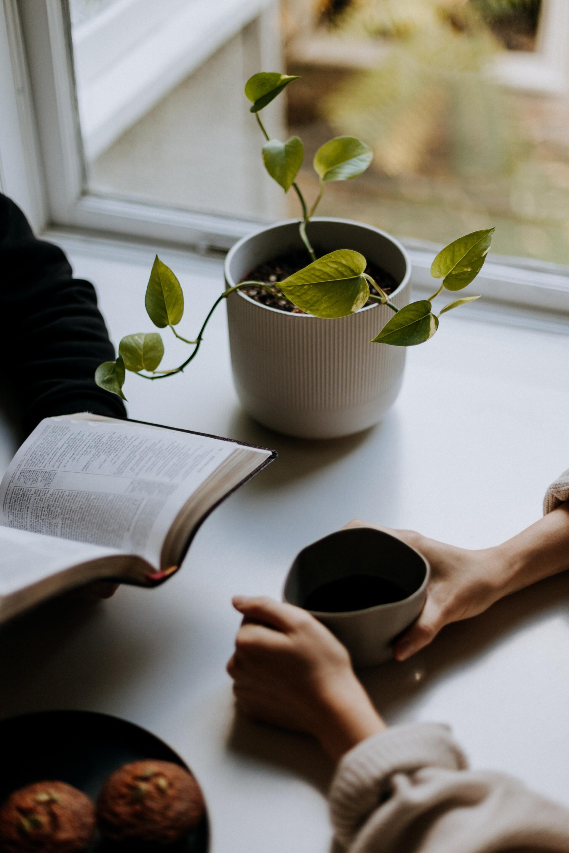 Two people studying a Bible at a table, representative of Christian discipleship