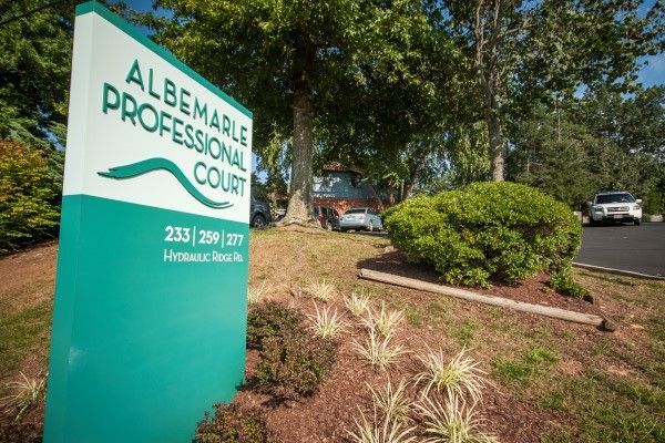A sign for the albemarle professional court is in front of a building.