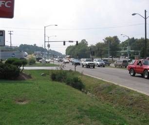 A busy street with a kfc sign in the background