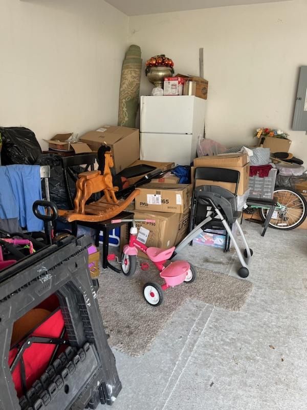 A garage filled with lots of boxes and toys.