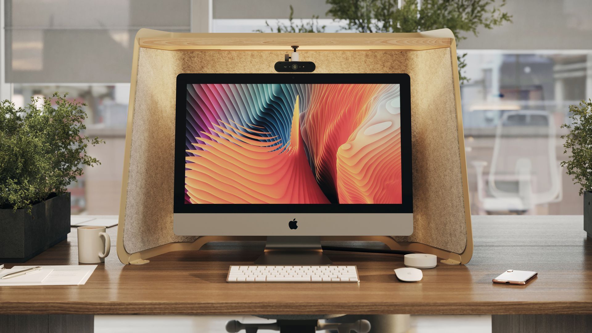 IMac on a wooden desk with a beige screen hood and a keyboard; plants in background.