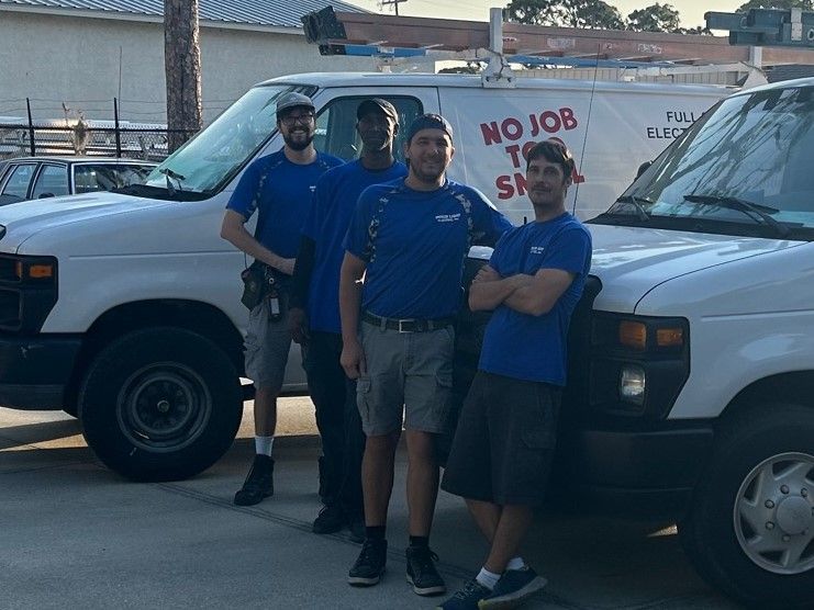A group of men are standing in front of a no job too small van. | Sarasota, FL | Inner Light Electric