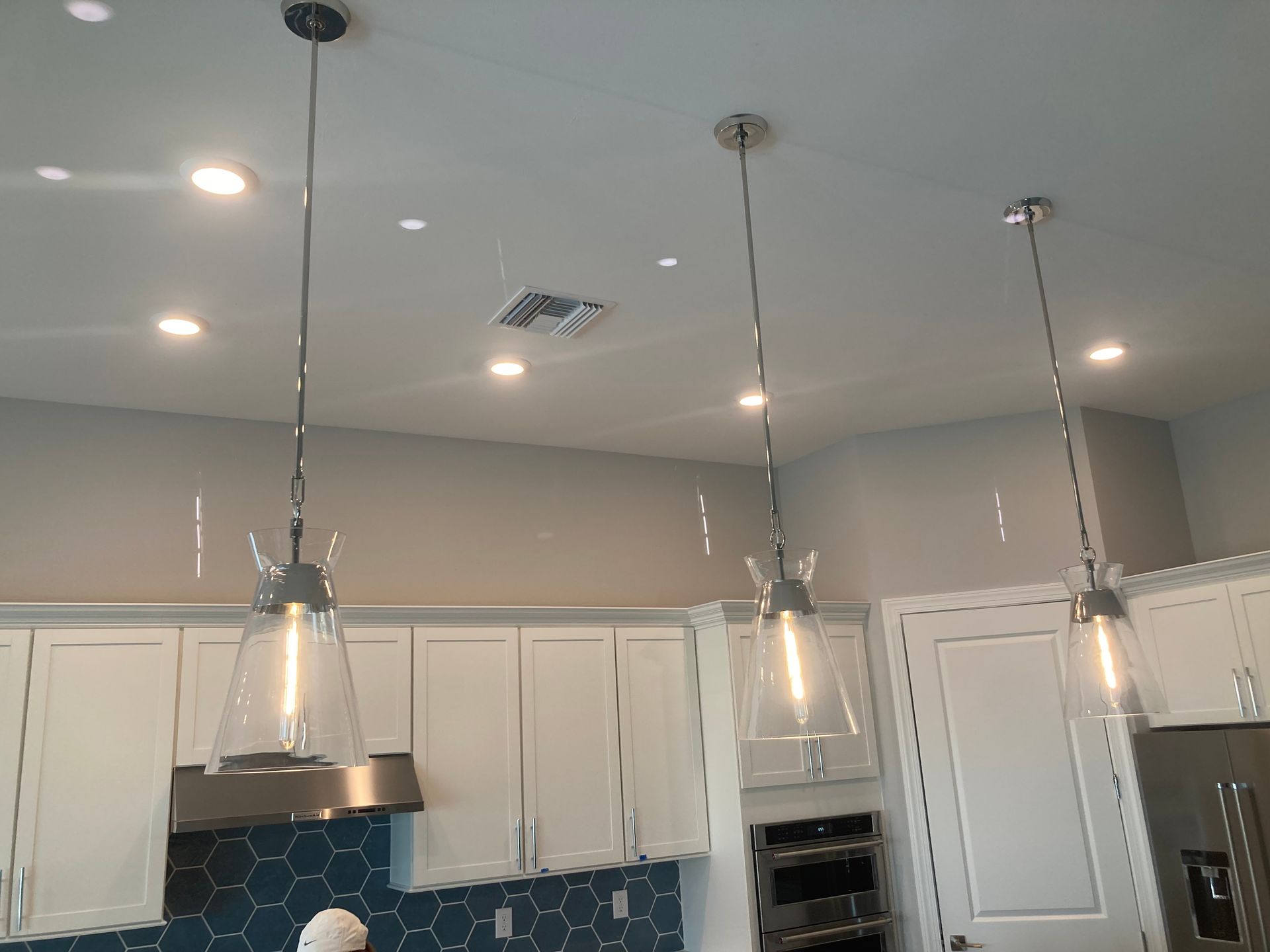 A kitchen with three pendant lights hanging from the ceiling | Sarasota, FL | Inner Light Electric