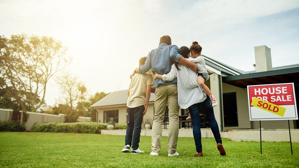 Happy Family With New House — Kalamazoo, MI — Carlson Realtors & Development