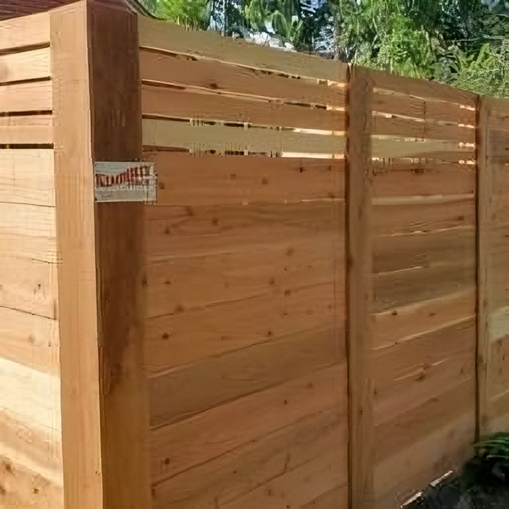 Wooden privacy fence with horizontal planks, light brown color.