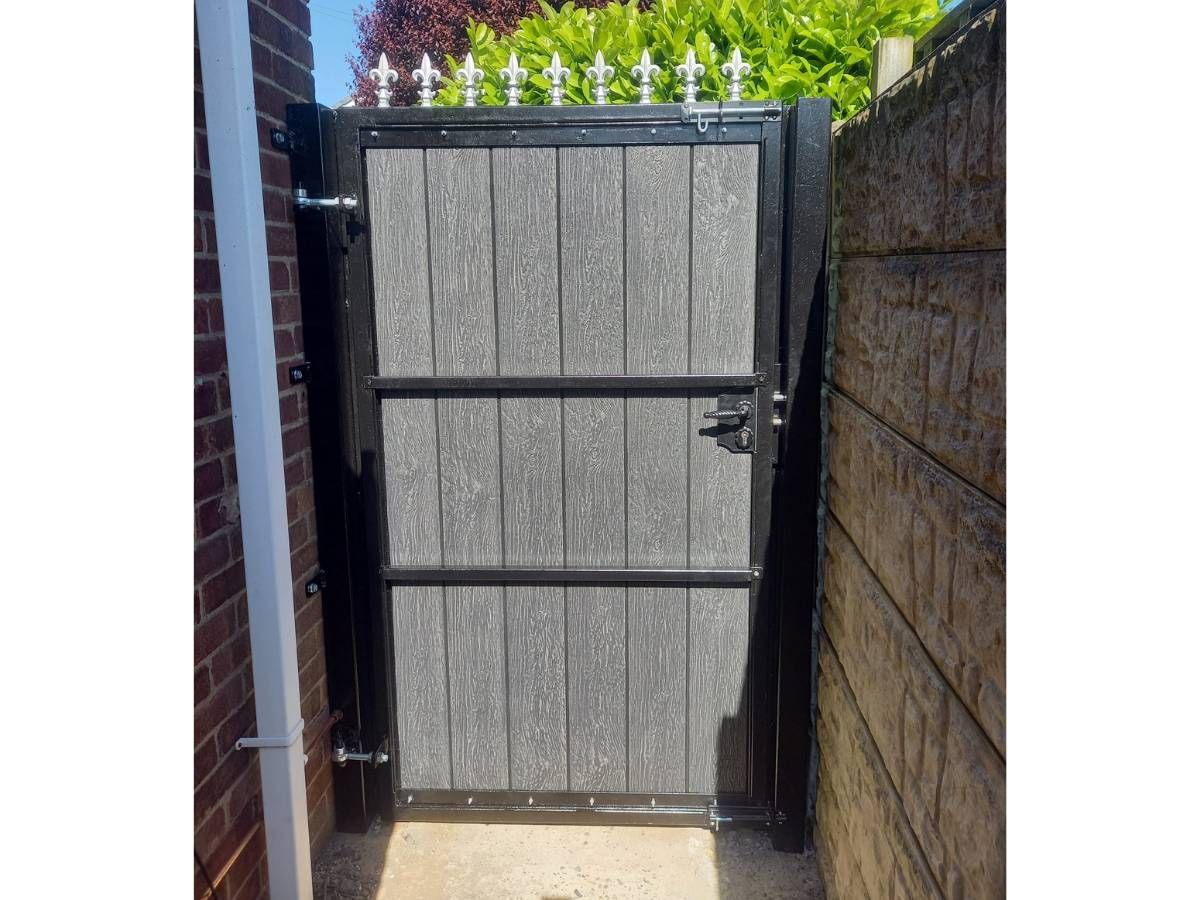 Interior view of a metal framed composite gate showing the decorative fleur-de-lis top rail detail — bespoke fabrication by Nottingham Metalworks
