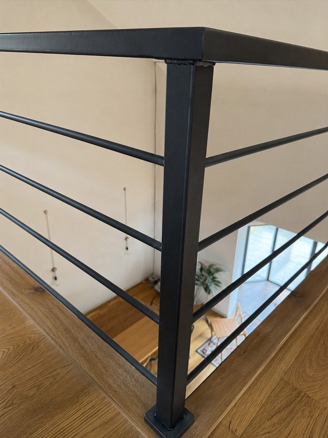 Close-up detail of a steel mezzanine balustrade post and handrail junction, black satin finish, fabricated by Nottingham Metalworks