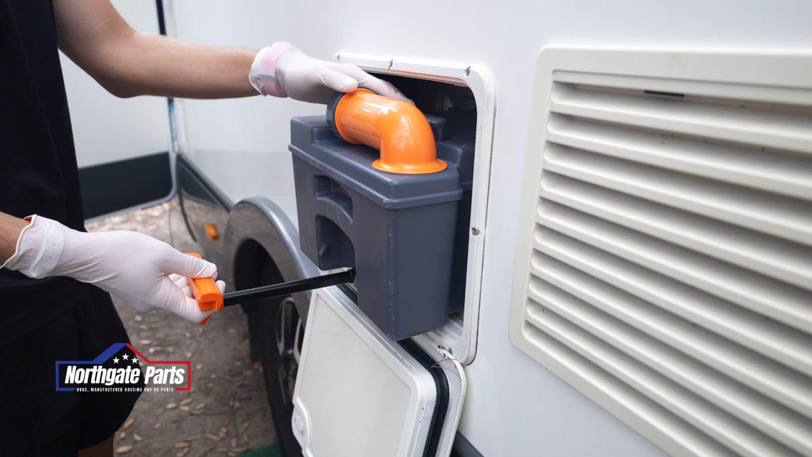 Person emptying a portable RV toilet cassette; white gloves, orange hose, and black waste tank.
