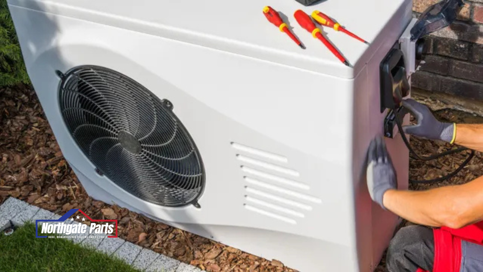 A man is working on a heat pump in a yard.