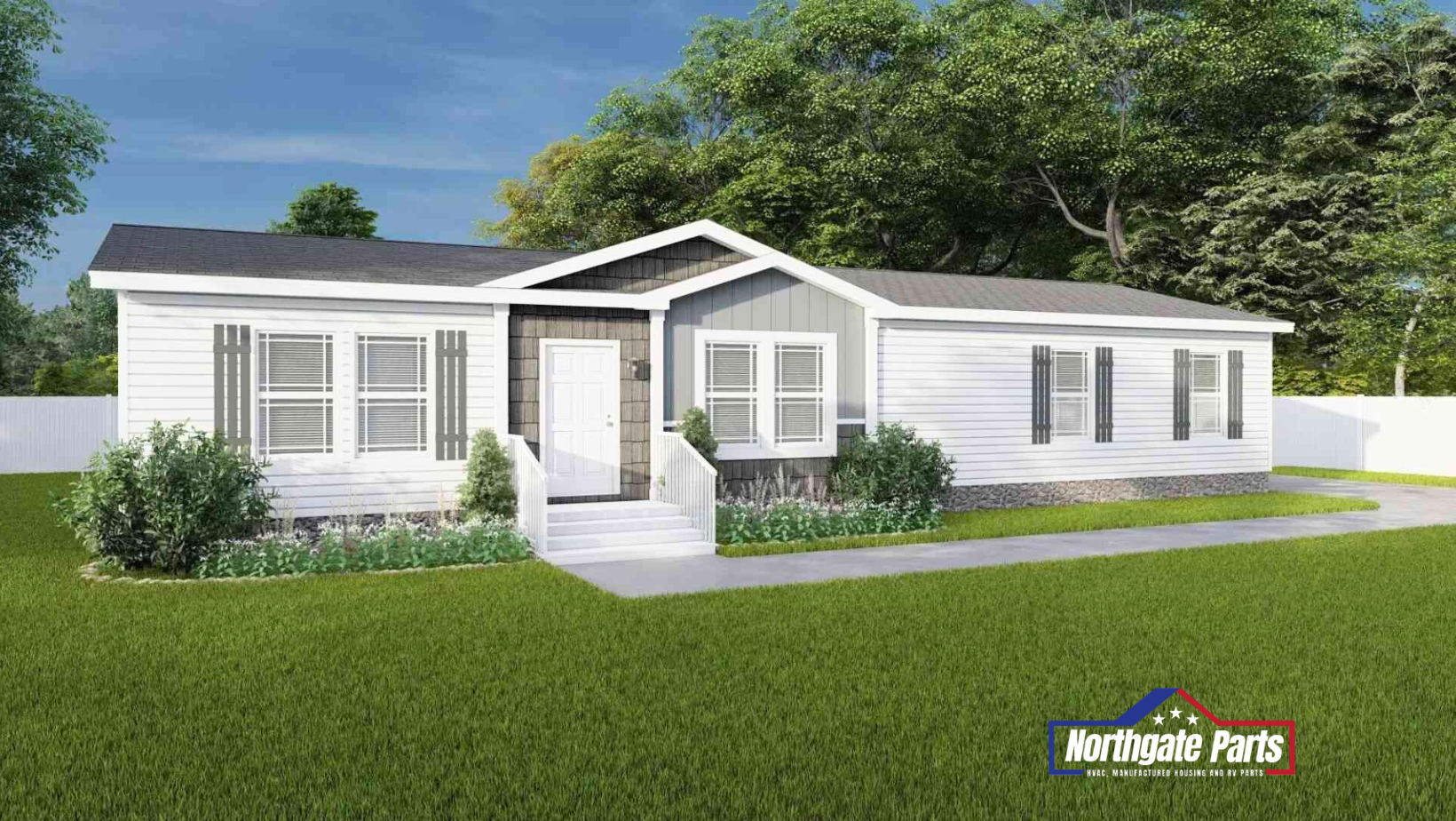 A white mobile home with a gray roof is sitting on top of a lush green lawn.