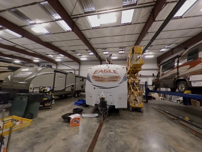 A white eagle rv is parked in a garage