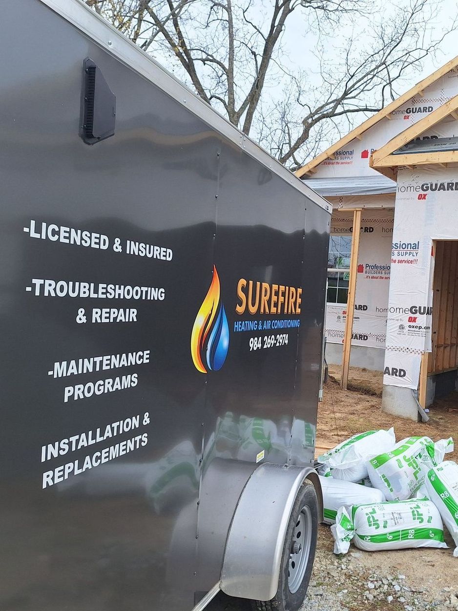 Surefire Heating and Air Conditioning trailer outside a construction site