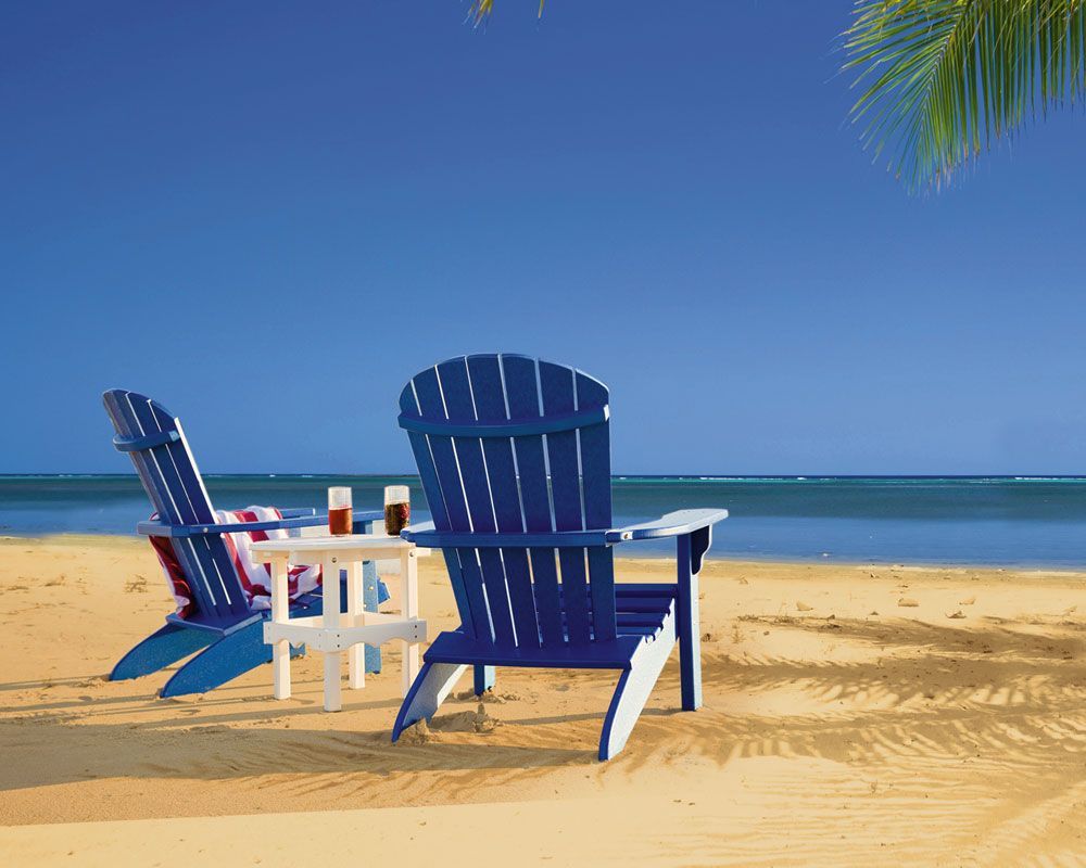 Two blue and white adirondack chairs on a sandy beach Two blue and white adirondack chairs on a sandy beach