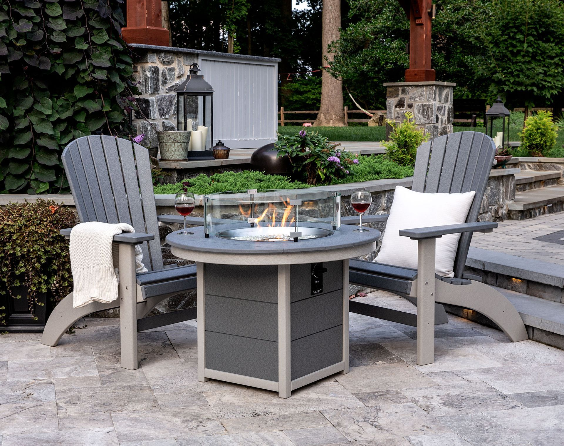 Two chairs are sitting around a fire pit on a patio Two chairs are sitting around a fire pit on a patio