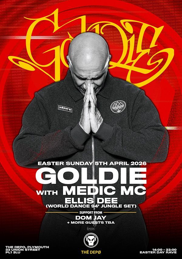Goldie album cover with a bald man in black praying hands on a red background, bold yellow lettering.