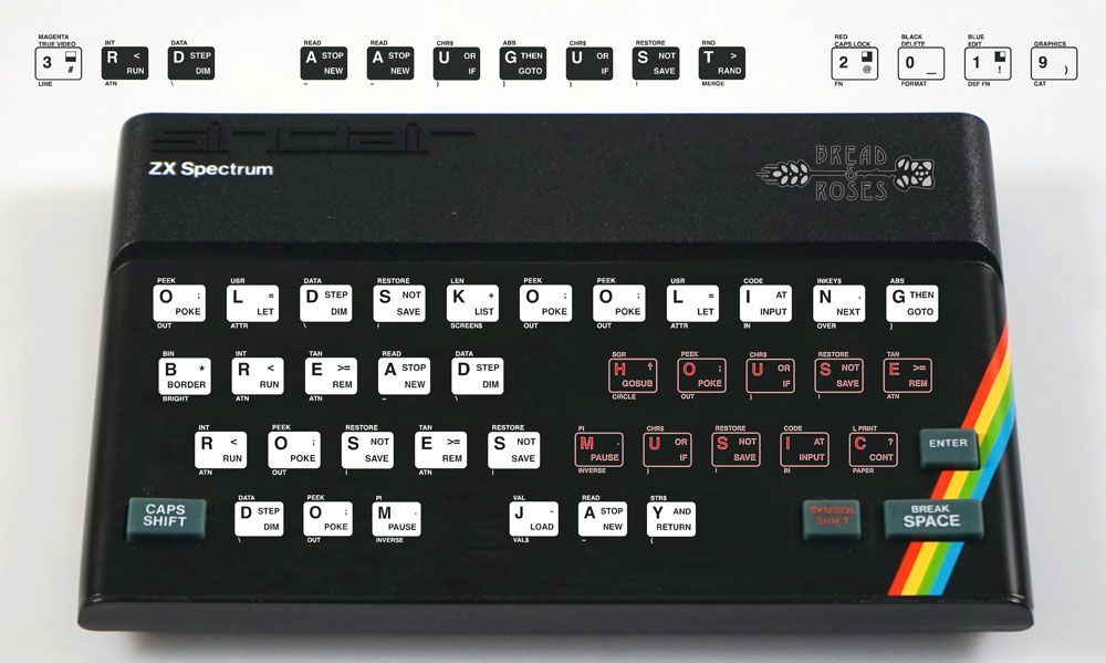 Zx Spectrum computer with a black keyboard and rainbow stripe on the right side