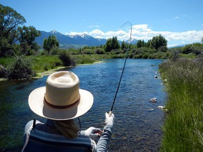 A person in a wheelchair is fishing in a river.