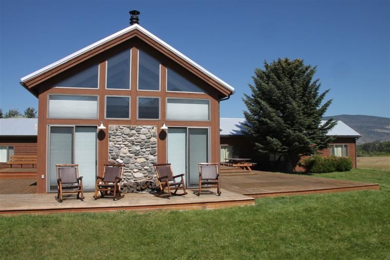 A house with rocking chairs in front of it