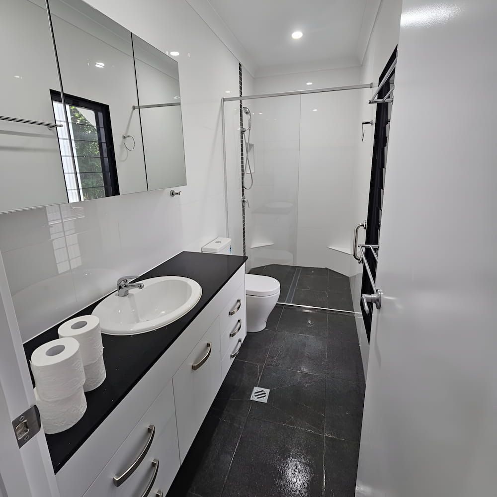 A Bathroom With Two Rolls Of Toilet Paper On The Counter — Glittering Cleaning Service In Townsville, QLD