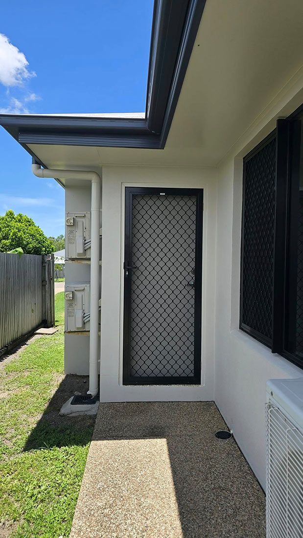 A White House With a Black Door and a Window — Glittering Cleaning Service In Townsville, QLD