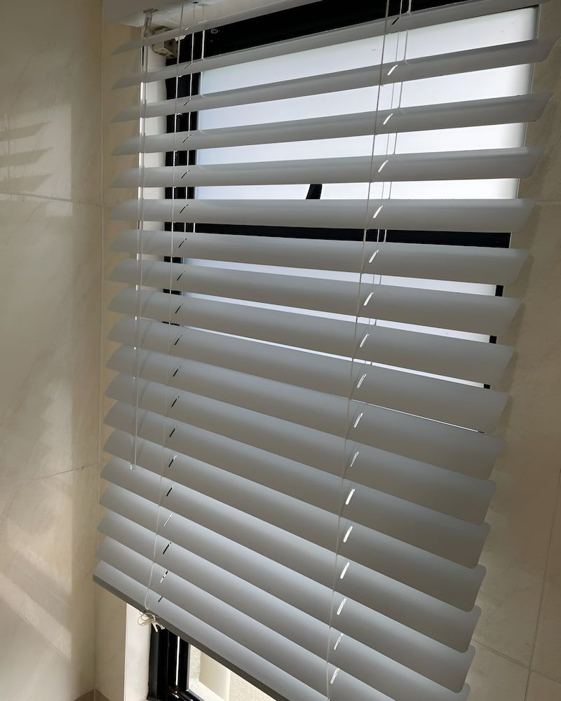 A Close Up Of A White Blind On A Window — Glittering Cleaning Service In Townsville, QLD