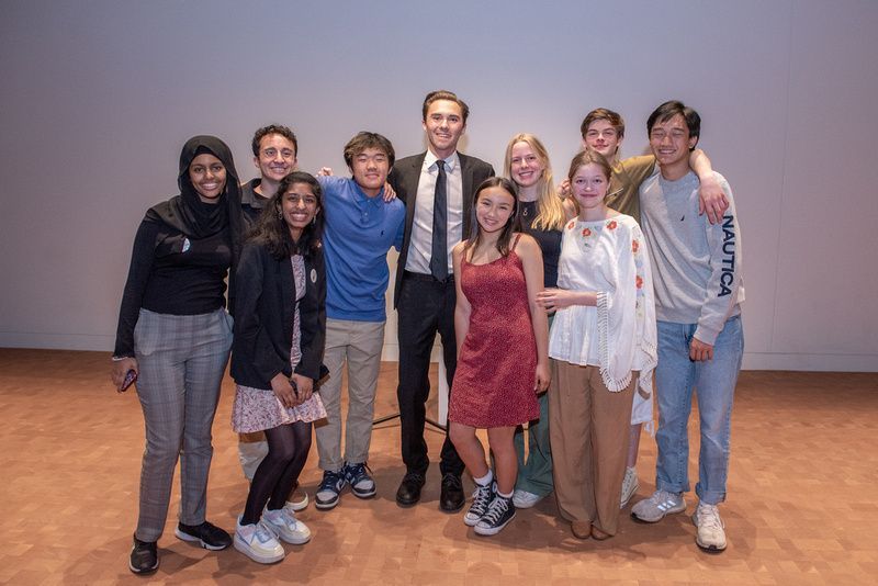 A group of people are posing for a picture together in a room.