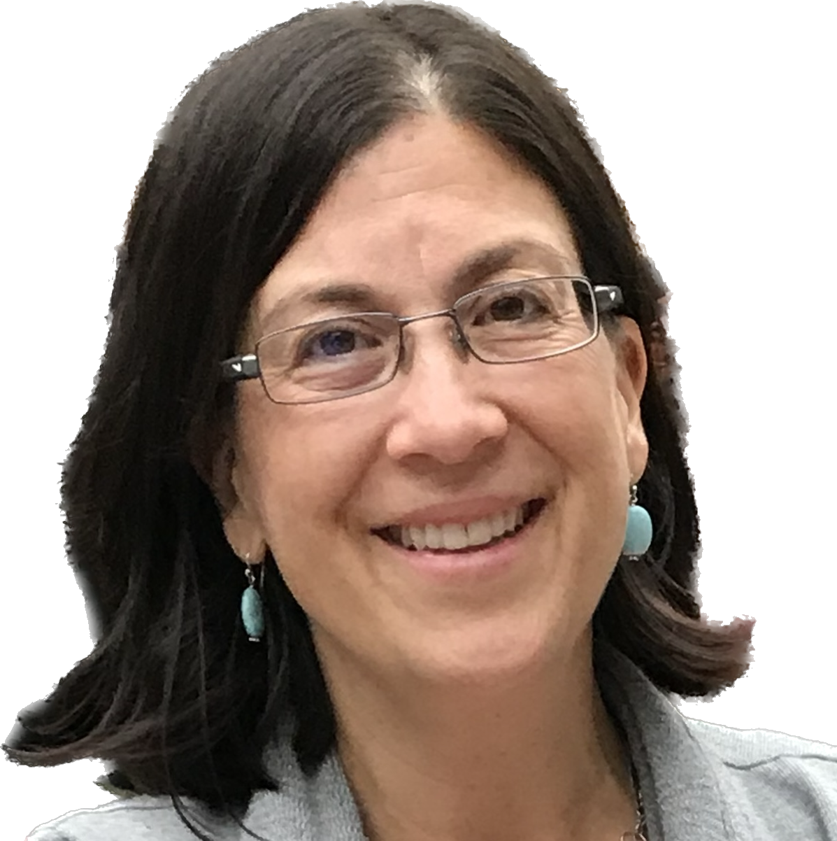 A woman wearing a scarf and a necklace is smiling for the camera.