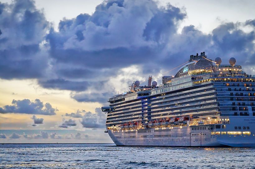 A large cruise ship is floating on top of a body of water.