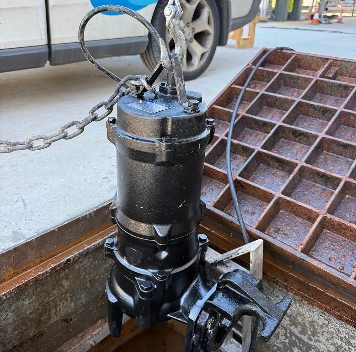 Black Pump Being Lifted from a Drain — PUMPtek in Grovedale, VIC