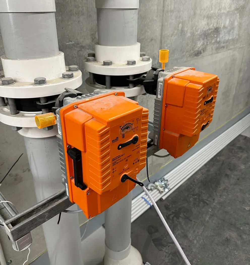 Two orange industrial control boxes mounted on gray pipes in a utility roo — PUMPtek in Bendigo, VIC