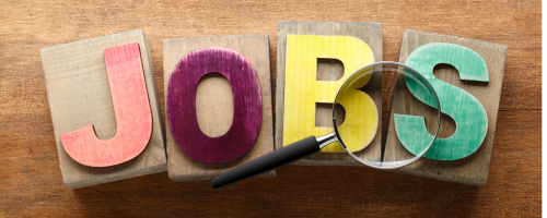 Blocks Spelling out the word jobs and magnifying glass
