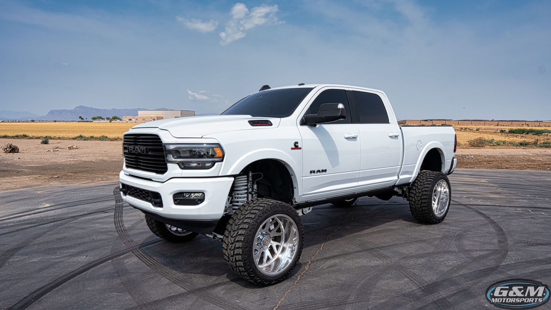 White Lifted Truck With Black Wheels Parked In Driveway | G & M Motorsports