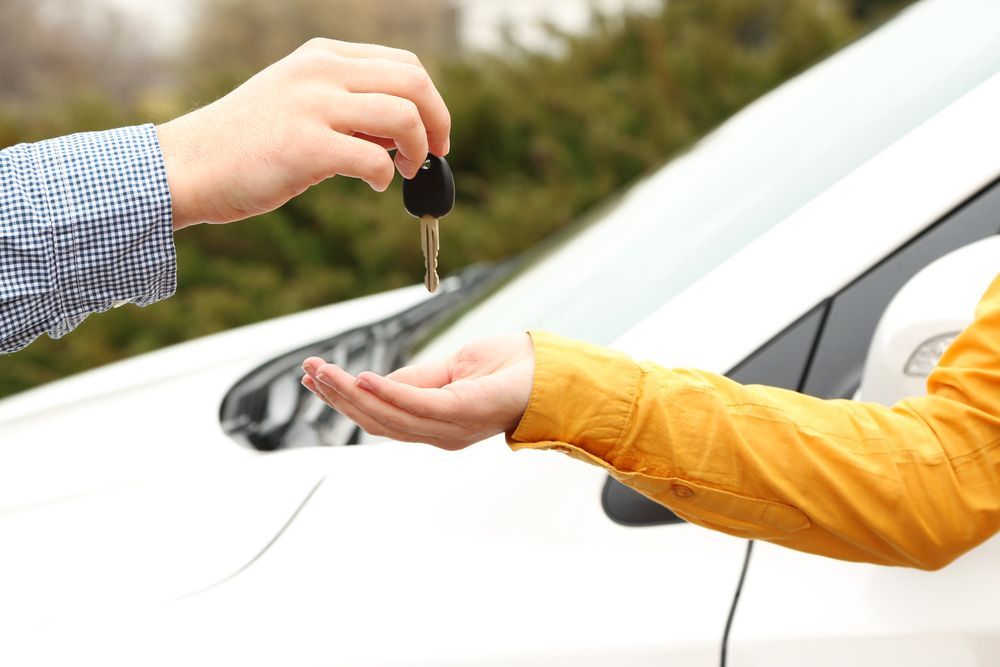 Car Rental Agent Handing Keys To A Customer — Locqal Car Truck Trailer Rentals in Emerald, QLD