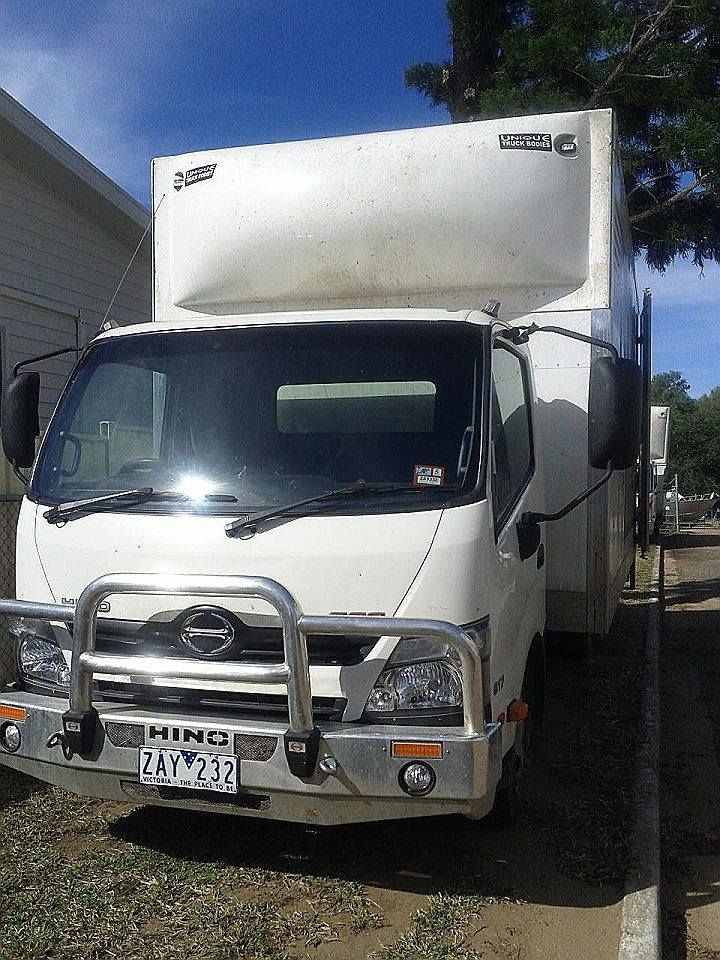 Front view of a white Locqal hire truck with hydraulic tailgate lift in Emerald