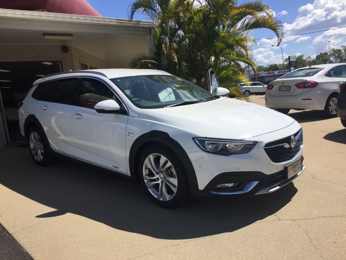 A White Car is Parked in Front of a Building — Locqal Car Truck Trailer Rentals in Emerald, QLD