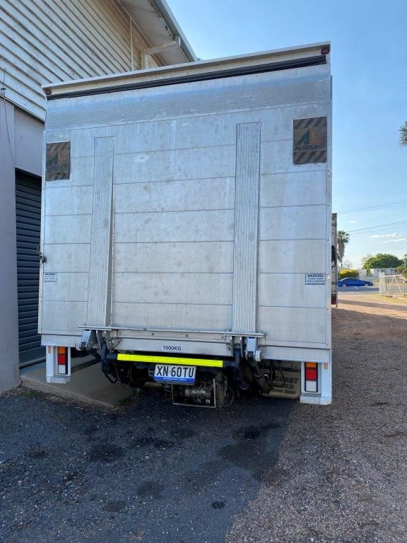 Rear view of a white Locqal hire truck with hydraulic tailgate lift in Emerald, QLD