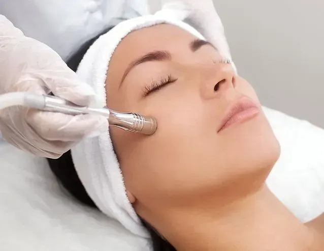 A Person Receives a Microdermabrasion Facial Treatment — Aura Mediclinic in Ashmore, QLD