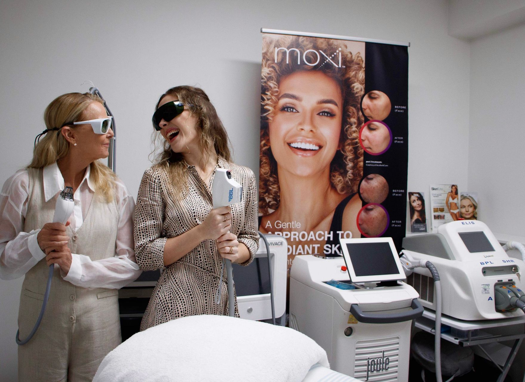 A Woman is Touching Her Face With Her Hands and Smiling — Aura Mediclinic in Ashmore, QLD