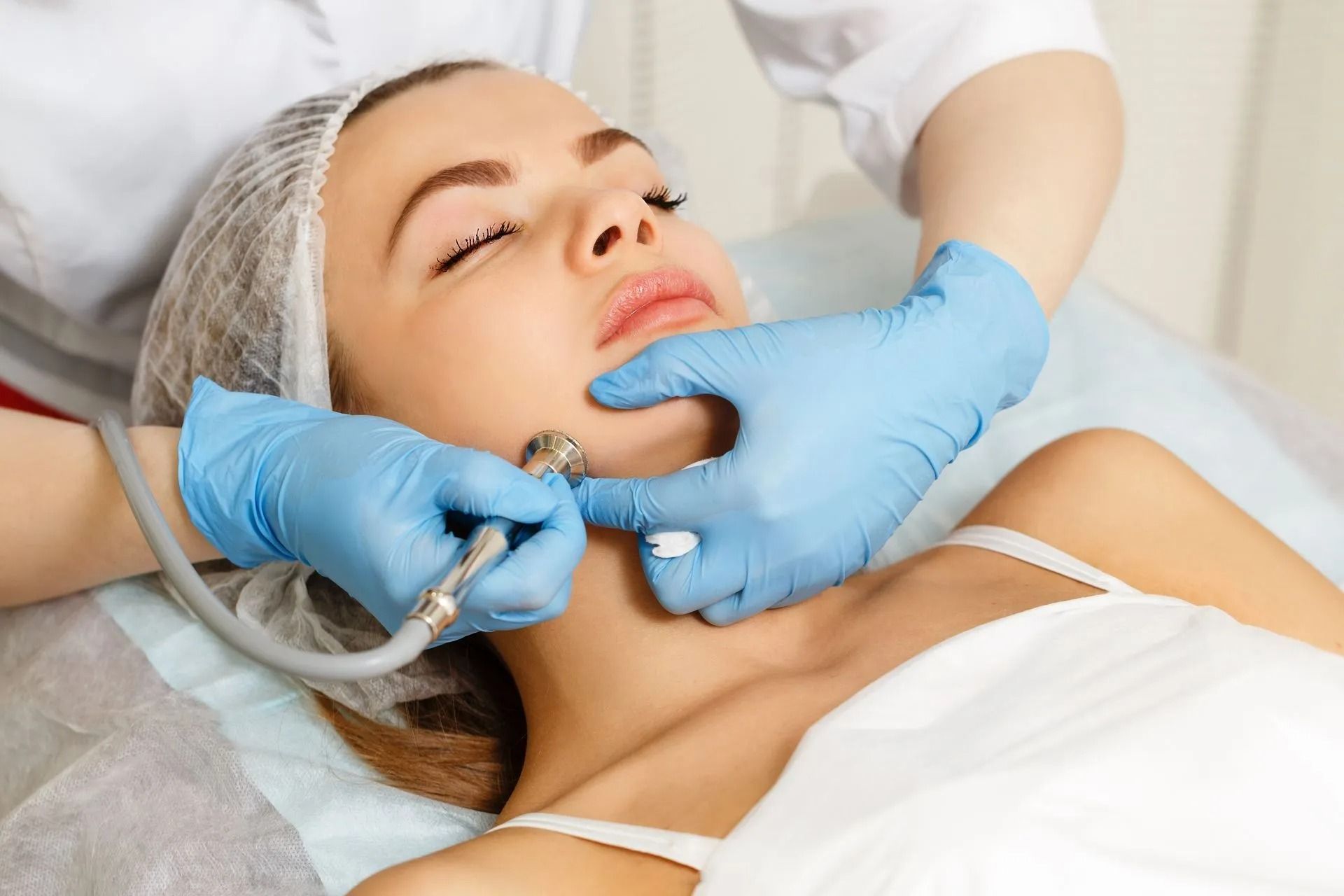 Woman With Closed Eyes Receives a Microdermabrasion
