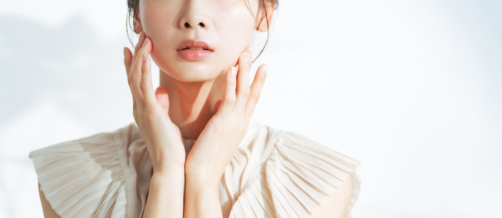 A woman touching her face with both hands